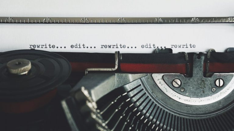 Classic typewriter with text 'rewrite... edit...' on paper.