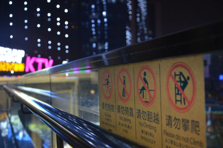 a close up of a sign on a railing